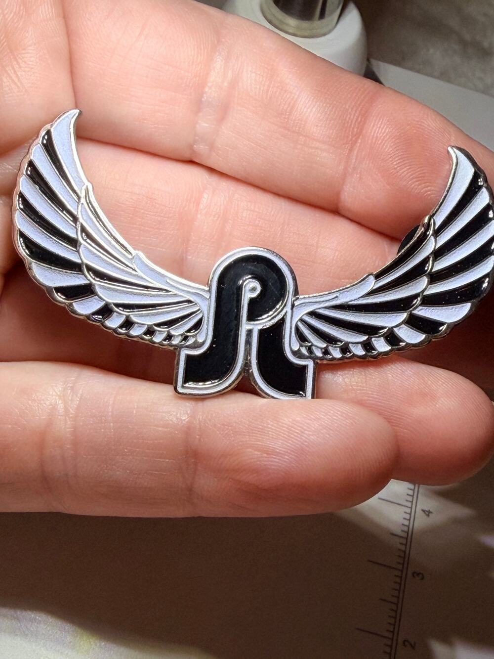 DirtySquirtz Pin Press #076 Winged R Logo Enamel Hat Pin Black White EDM